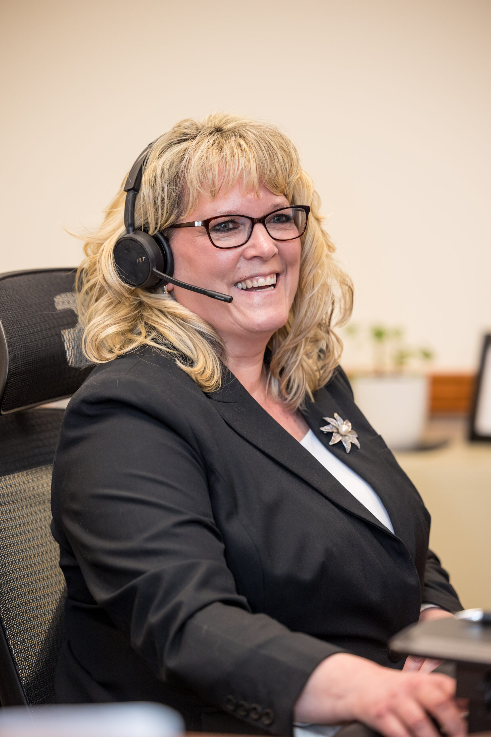 professional female receptionist sitting with headset on